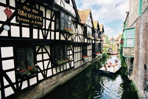 A photo of the river below The Old Weavers House, with people on boat tours going down it