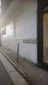A white brick wall that has been cleaned of graffiti Whitehorse Lane
