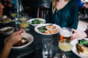 A photo of some people seated and eating brunch