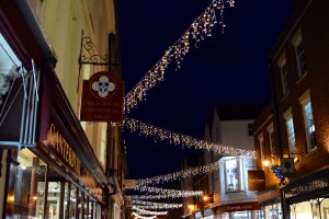 Hanging christmas lights in a Canterbury street