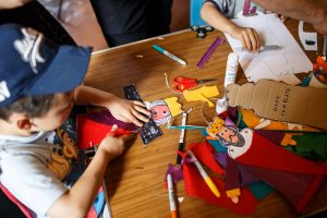 Some small children partaking in medieval themed crafts