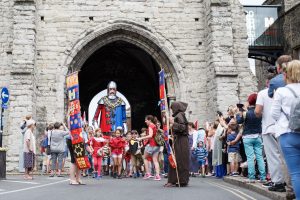 Children in costume marching in the medieval pageant