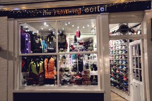 A festively decorated The Running Outlet window