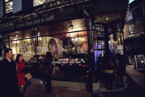 People walking past and entering La Trappiste cafe