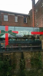 A festively decorated The Pound windows