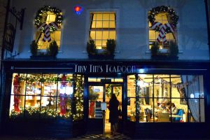 A festively decorated Tiny Tim's Tearoom windows