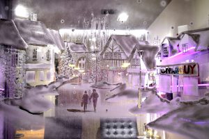 A drawing of a winter street in fake frost on a Toni & Guy window