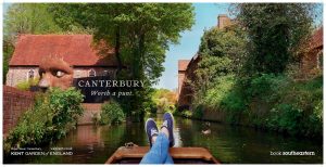 A photo of a persons legs cruising in a river boat with text over it that reads Canterbury - Worth a punt