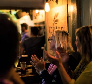 Some people applauding in a pub