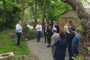 A group of people gathered outside in celebration, drinks in hand