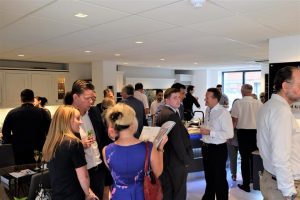 A room of people socialising and networking at a Designed Interiors event