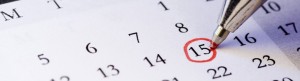 The fifteenth date of the month circled in red on a calendar