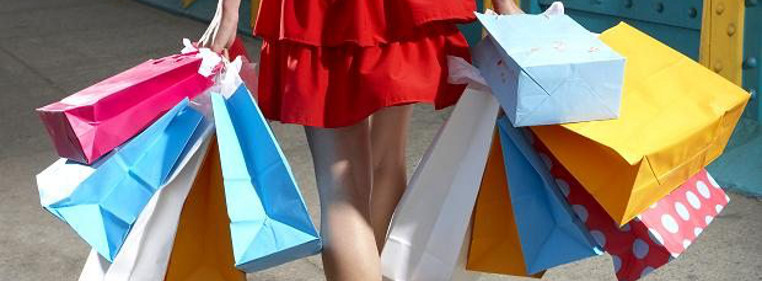 A woman walking and holding shopping bags