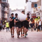 Some people in carrying a sack of hops at the Hop Pocket Race