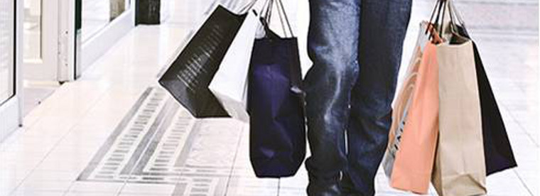 A person walking and holding shopping bags