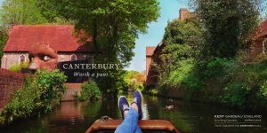 A photo of a persons legs cruising in a river boat with text over it that reads Canterbury - Worth a punt