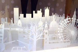 Paper cut-outs of British landmarks in a Cath Kidson window