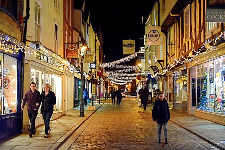 A Canterbury street at night, lit by hanging christmas lights