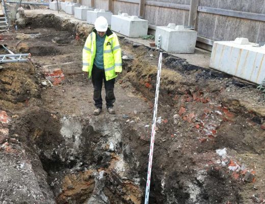 A man standing in the middle of outdoor construction