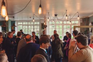 A room of people socialising and networking at an event