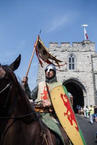 A man dressed as a medieval knight on horseback