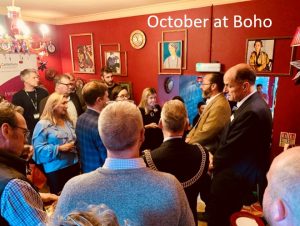 A photo of a room of people socialising, with text above it that reads October at Boho