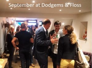A photo of a room of people socialising, with text above it that reads September at Dodgems & Floss