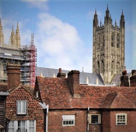 A photo of some rooftops with Canterbury Cathedral in the background