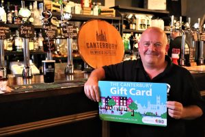 Jon Mills holding an enlarged novelty Canterbury Gift Card