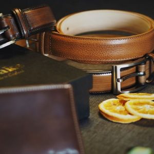 A photo of some brown leader belts on a table
