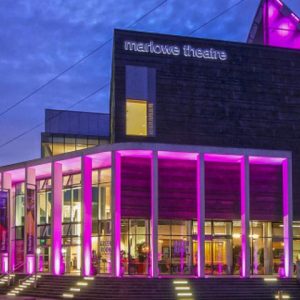 Marlowe Theatre in the evening, lit by pink lights