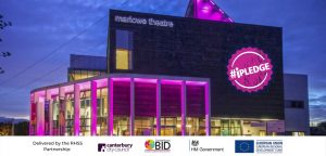 Marlowe Theatre in the evening, lit by pink lights
