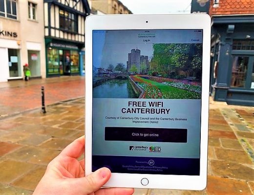 A photo of an iPad being held up by a person, with a log in page for free Canterbury wifi displayed on it