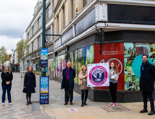 A photo of six people posing for a photo, socially distanced, celebrating the reopening of Canterbury City Centre