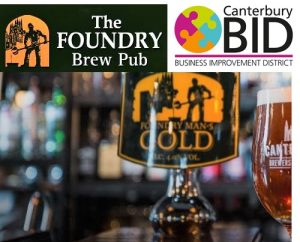 A photo of a bar with a logo above for The Foundry Brew Pub, as well as the Canterbury Bid logo beside it