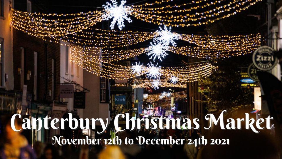 A photo of Canterbury high street at night, lit with Christmas lights with text beneath that reads Canterbury Christmas Market - November 12th to December 24th 2021