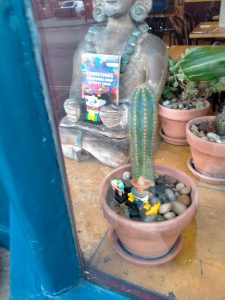 A photo of a Mexican themed Lego display in the window of Cafe Des Amis