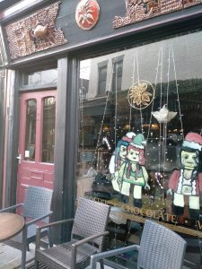 A photo of some large drawings of Lego figures in a shop window
