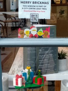 Some Lego wrapped presents in a shop window