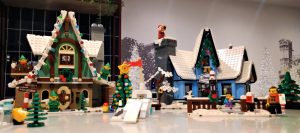 A photo of a Christmas Lego display, with people and snowy houses, inside Hampton by Hilton