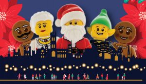 A photo of some christmas themed Lego figures over the Canterbury city skyline