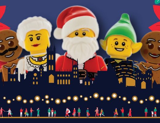 A photo of some christmas themed Lego figures over the Canterbury city skyline