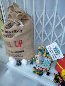 A photo of some Lego figures and Pokémon cards in a shop window