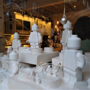 A photo of snowy white Lego figures in a shop window