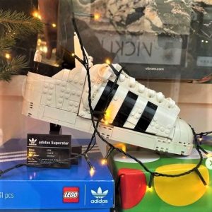 A photo of an Adidas shoe made from Lego in a shop window