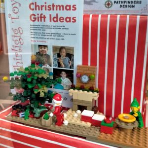 A photo of a christmas Lego display in a shop window