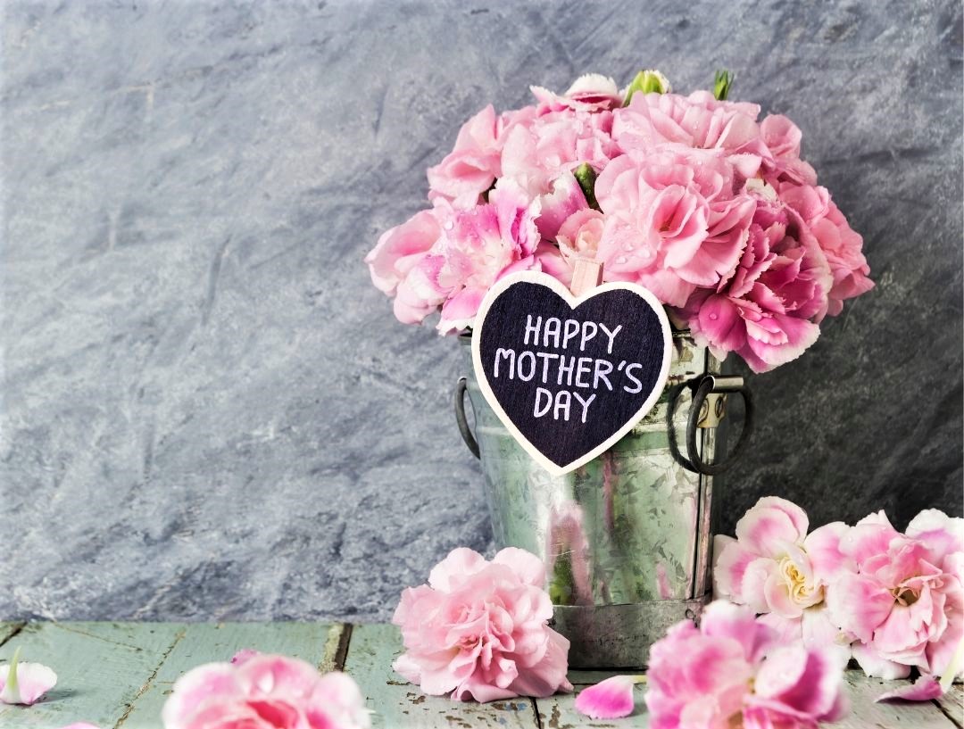 A photo of some pink flowers with a happy mother's day tag on them