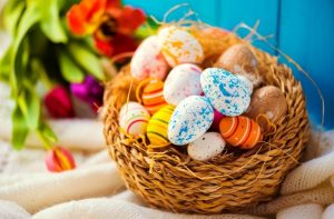 A photo of some painted easter eggs in a basket
