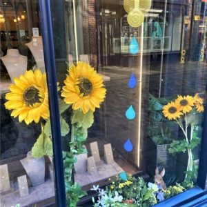 A photo of some sunflowers in a shop window