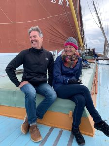 A photo of a man and a woman sitting on a boat and smiling